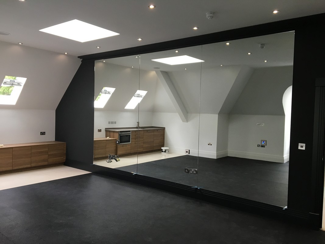 Frameless glass wall dividing loft conversion in Dalston