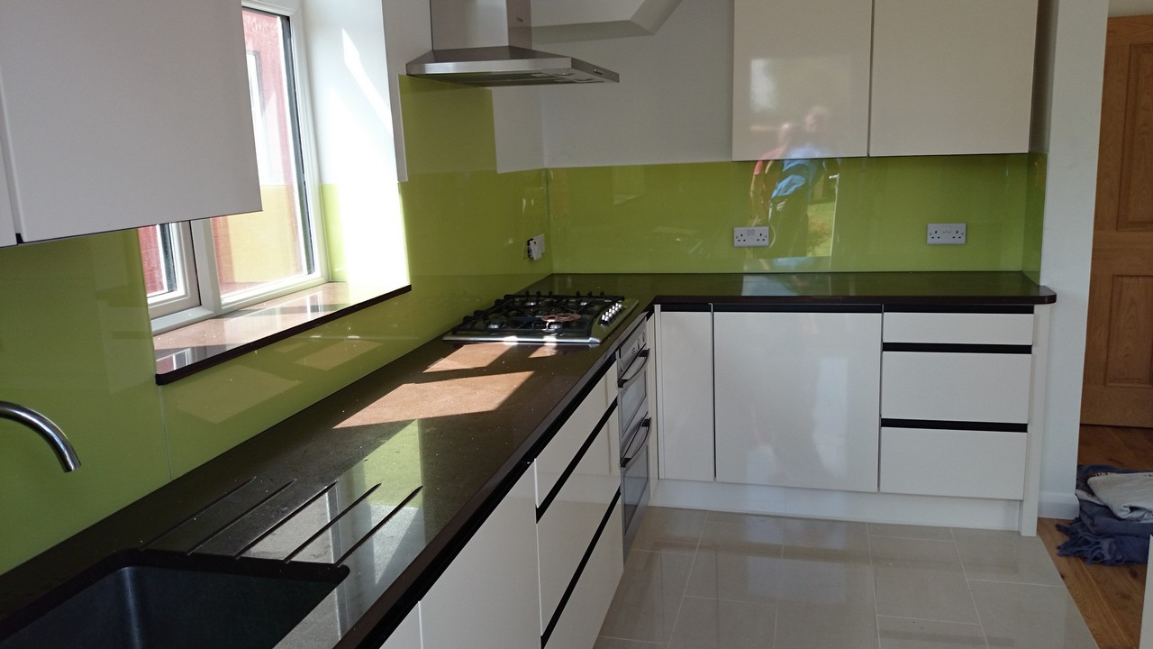 Lime green glass kitchen splashback installed by Dalston glaziers